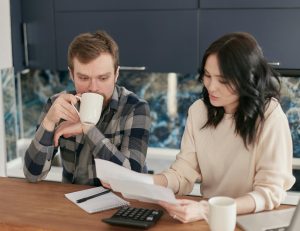 Person calculating loan affordability